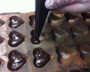 3. From there, ganache is piped into the cavities