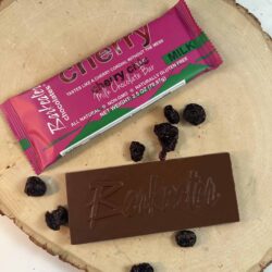 unwrapped and wrapped milk chocolate bar with dried cherries