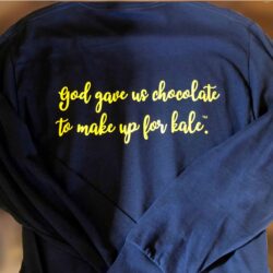 Navy blue long sleeved shirt with words god gave us chocolate to make up for kale on the back in yellow.