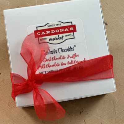 white small box with red ribbon and company logo
